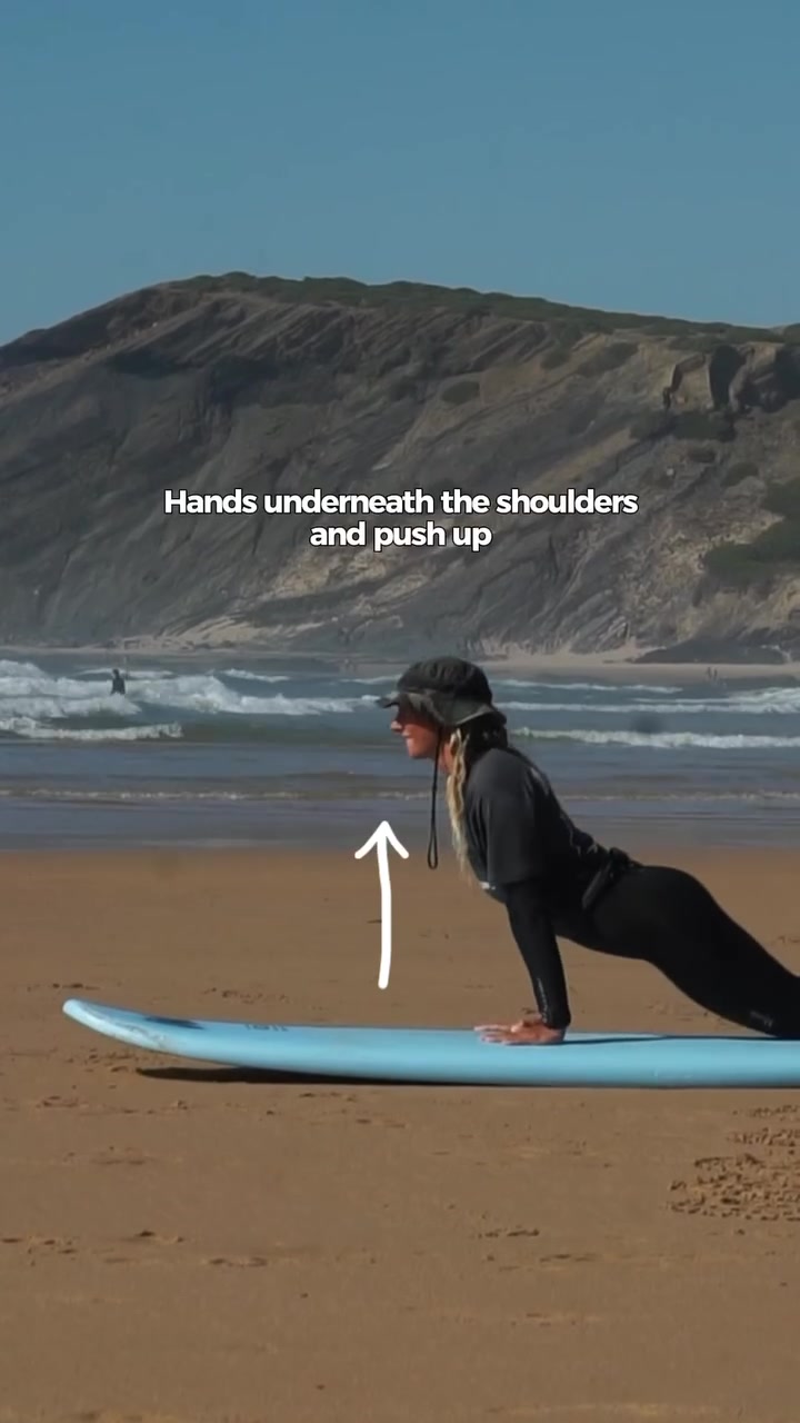 Learn how to POP UP in 3 steps 🌊 1. Cobra position 🐍 • Start by paddling strongly to catch the wave. As you feel the wave lift the board, place your hands flat on the board near 